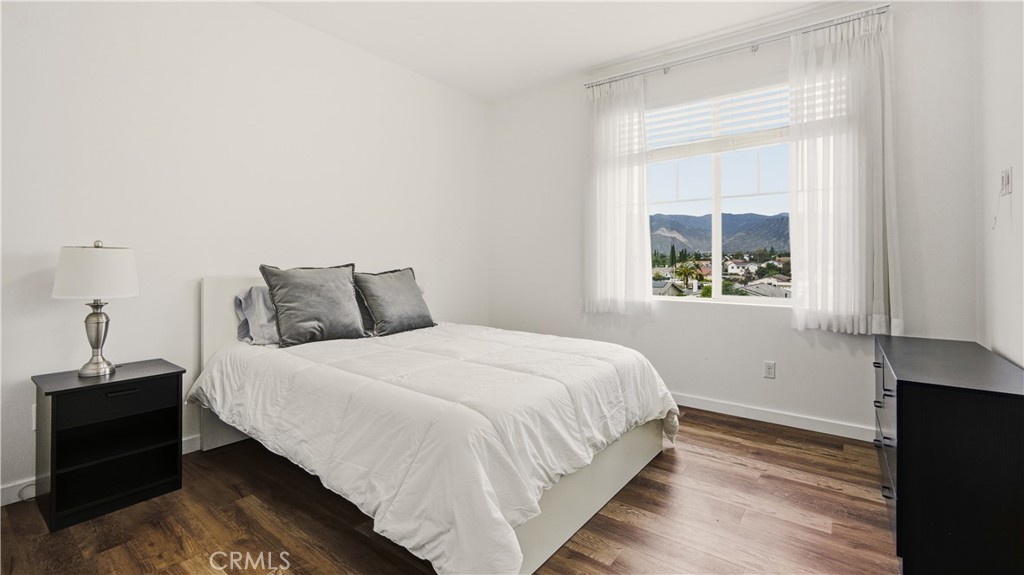713 South Azusa Avenue, Unit A Azusa, CA 91702 - Photo 20 of 31 a bedroom with a bed and wooden floor
