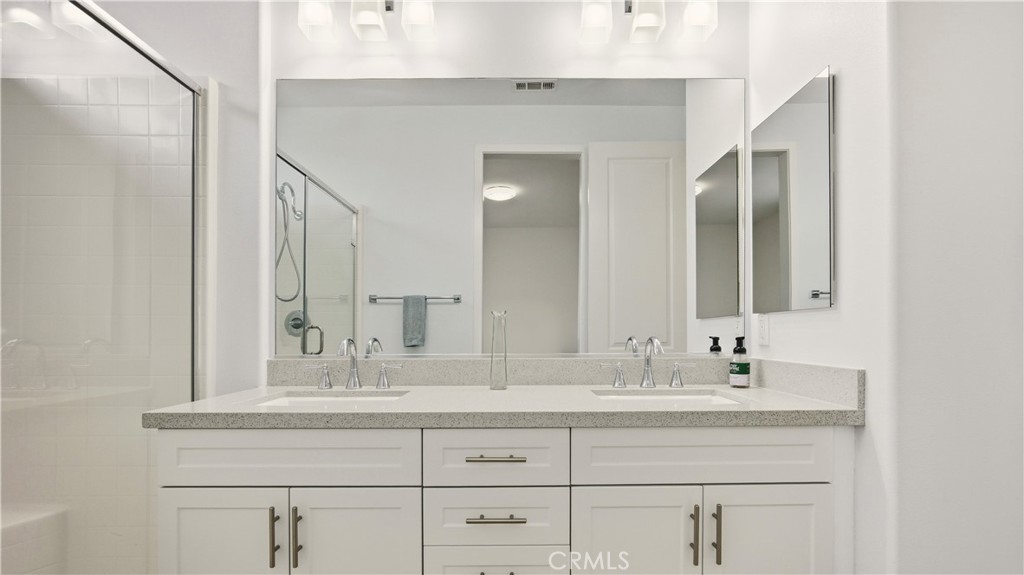 713 South Azusa Avenue, Unit A Azusa, CA 91702 - Photo 21 of 31 a bathroom with double vanity sink and a mirror