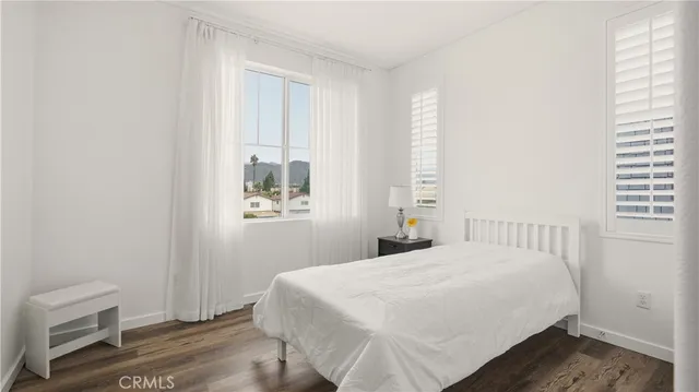 a view of a livingroom with wooden floor and staircase
