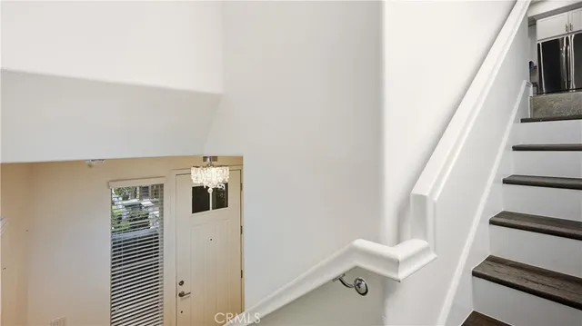 a kitchen with stainless steel appliances kitchen island granite countertop a refrigerator and a sink