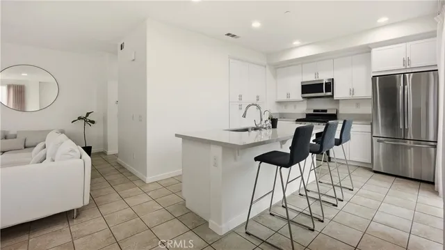 a kitchen with a sink stove and refrigerator
