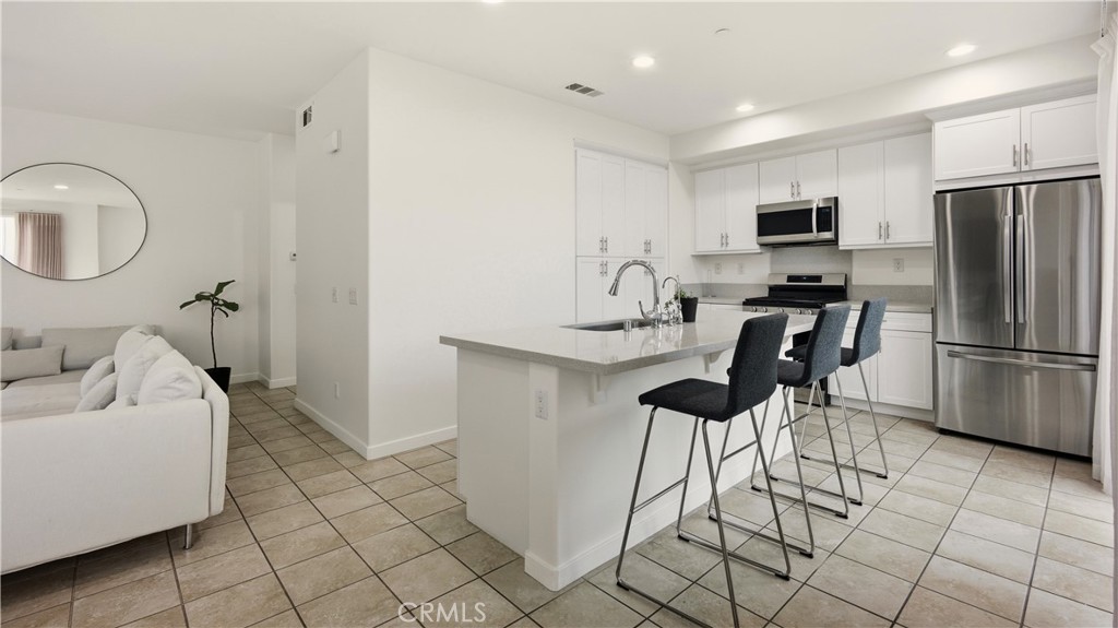 713 South Azusa Avenue, Unit A Azusa, CA 91702 - Photo 8 of 31 a kitchen with stainless steel appliances kitchen island granite countertop a refrigerator and a sink