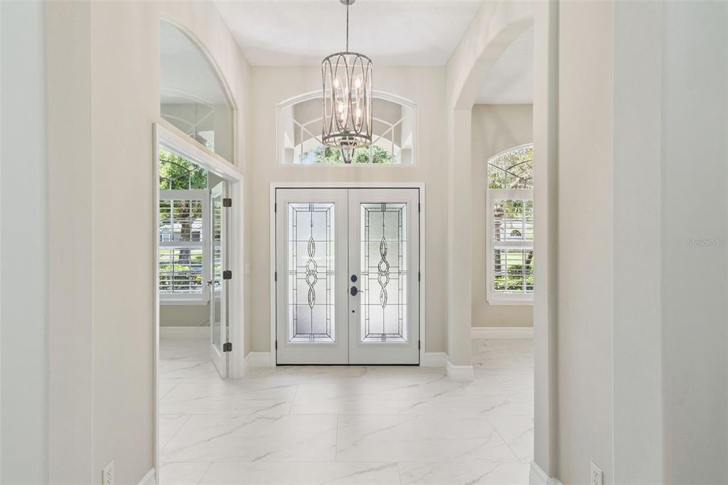 2230 Ridgewind Way Windermere, FL 34786 - Photo 5 of 38 an empty room with windows wooden floor and front door