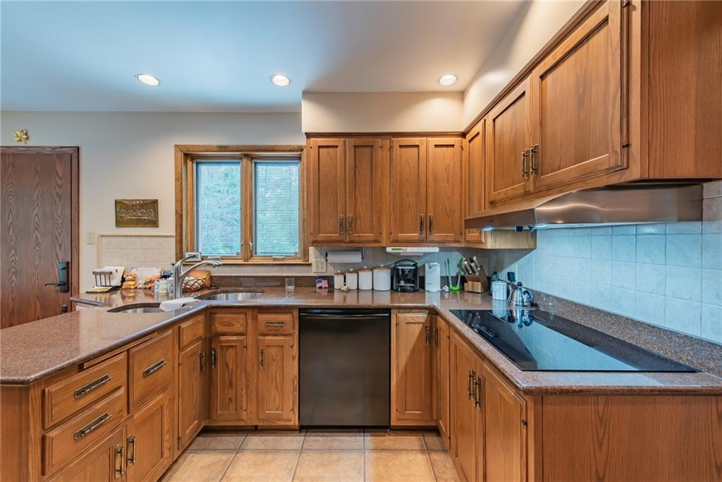 421 Center Church Road McMurray, PA 15317 - Photo 5 of 25 KITCHEN - Wood cabinetry with beautiful countertops and neutral backsplash, double corner sink and electric cooktop, recessed lights.