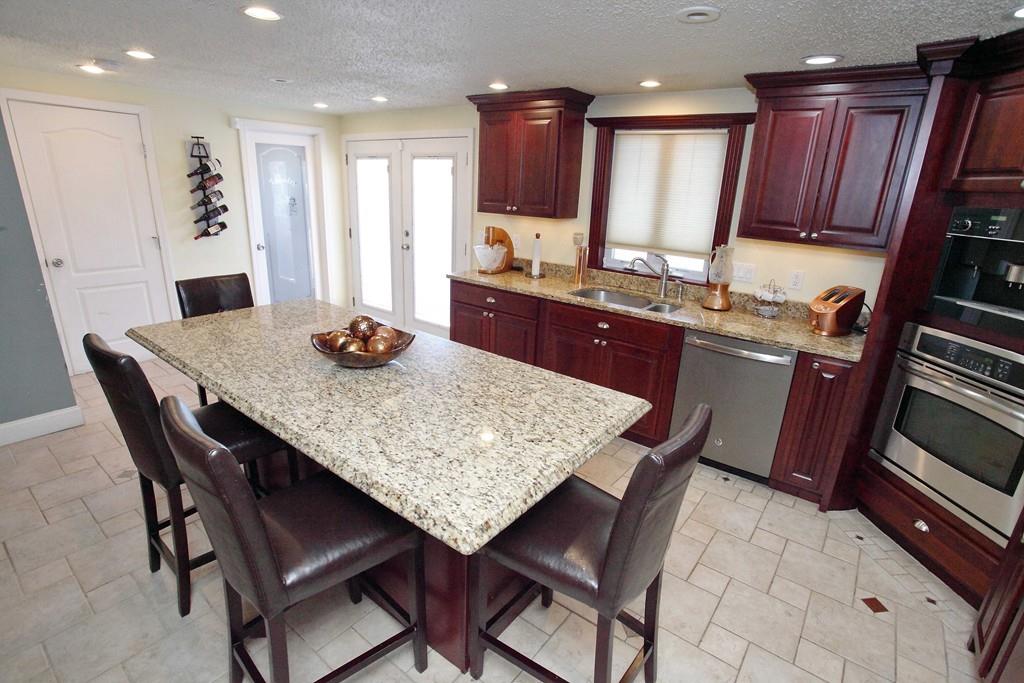 33 Gammons Road Acushnet, MA 02743 - Photo 12 of 37 a kitchen with granite countertop sink dining table and chairs