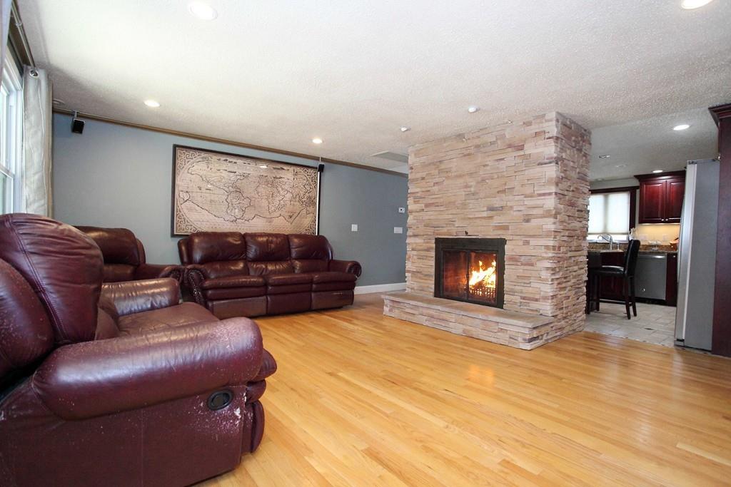 33 Gammons Road Acushnet, MA 02743 - Photo 4 of 37 a living room with furniture a fireplace and kitchen view