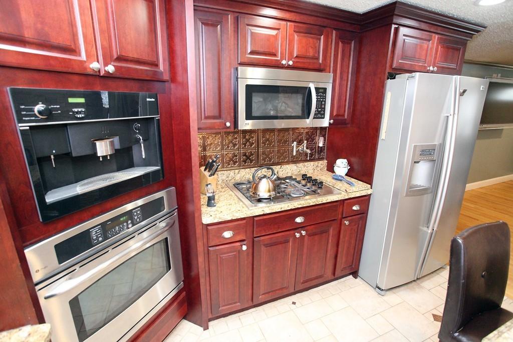 33 Gammons Road Acushnet, MA 02743 - Photo 8 of 37 a kitchen with granite countertop a stove microwave and refrigerator
