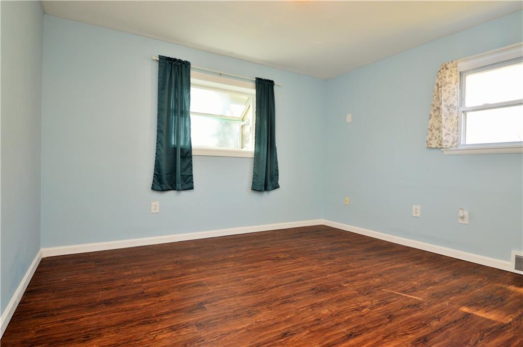 4905 Rochester Road New Brighton, PA 15066 - Photo 12 of 21 an empty room with wooden floor and windows