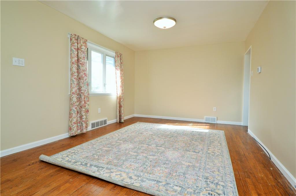 4905 Rochester Road New Brighton, PA 15066 - Photo 5 of 21 an empty room with wooden floor and windows