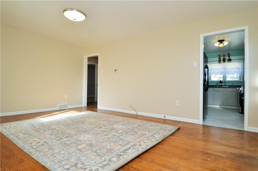 4905 Rochester Road New Brighton, PA 15066 - Photo 6 of 21 an empty room with kitchen view