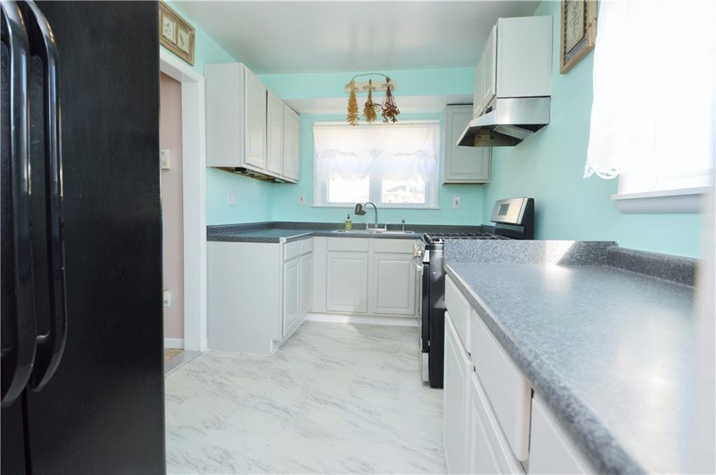 4905 Rochester Road New Brighton, PA 15066 - Photo 7 of 21 a kitchen with stainless steel appliances granite countertop a sink and a stove