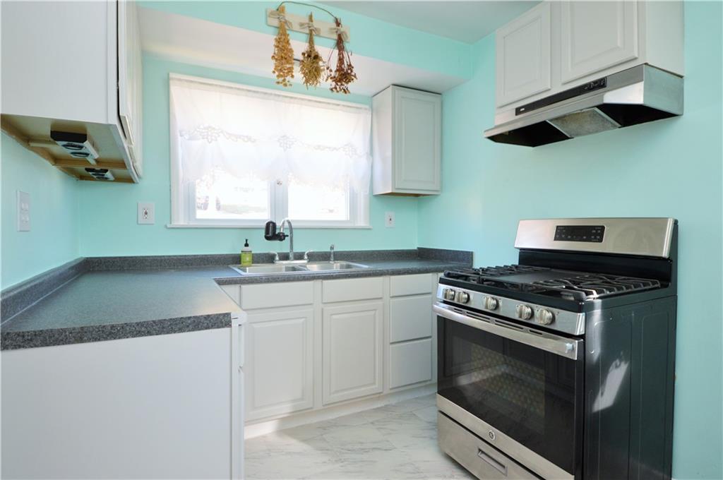 4905 Rochester Road New Brighton, PA 15066 - Photo 8 of 21 a kitchen with stainless steel appliances granite countertop a stove and a sink