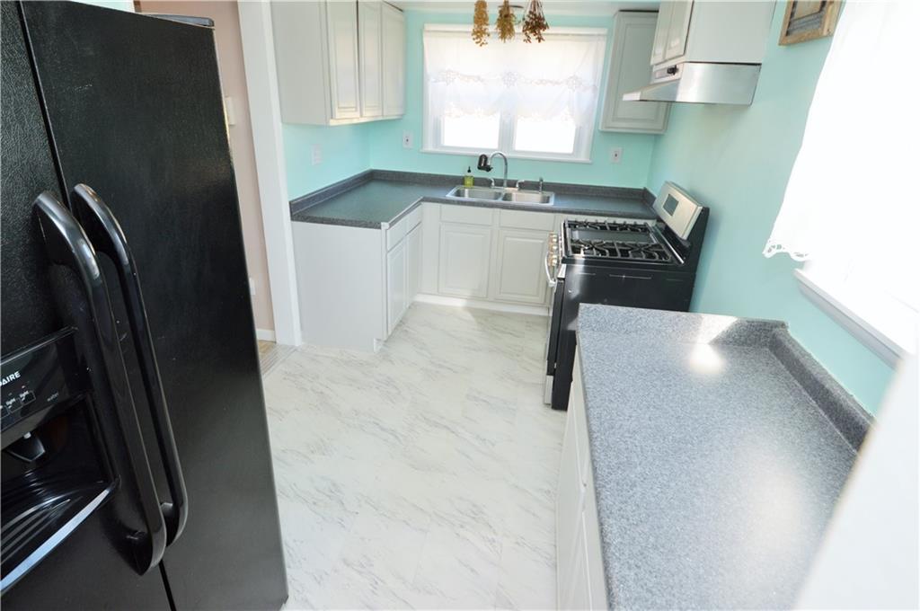 4905 Rochester Road New Brighton, PA 15066 - Photo 9 of 21 a kitchen with stainless steel appliances granite countertop a sink stove and refrigerator