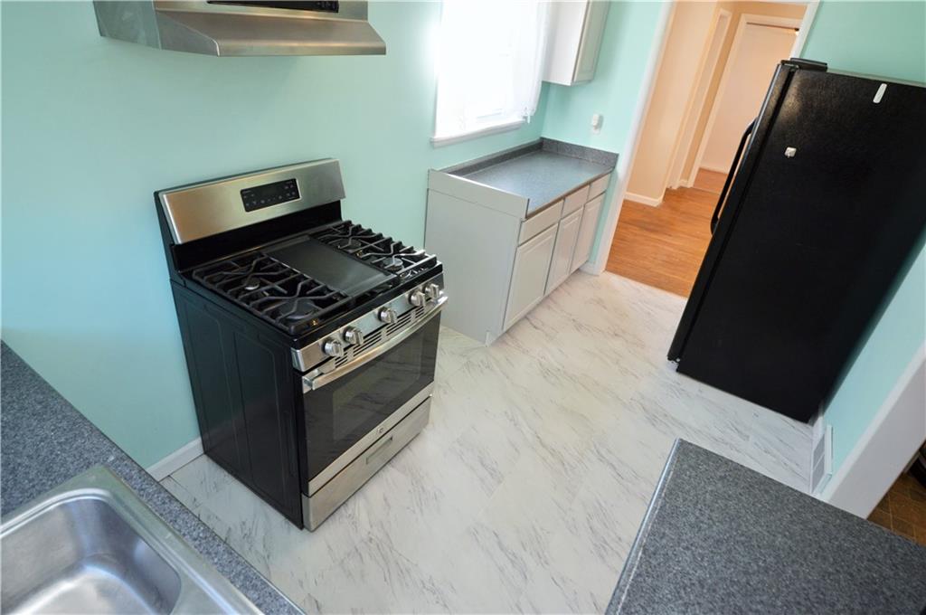 4905 Rochester Road New Brighton, PA 15066 - Photo 10 of 21 a kitchen with granite countertop a stove and a microwave