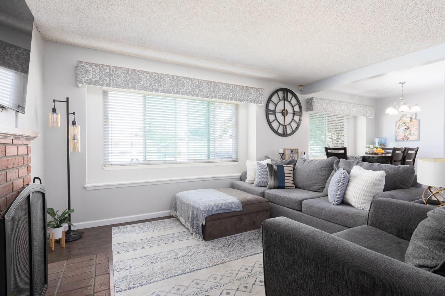 1226 Roxbury Court Santa Clara, CA 95050 - Photo 23 of 35 a living room with furniture a table and a large window