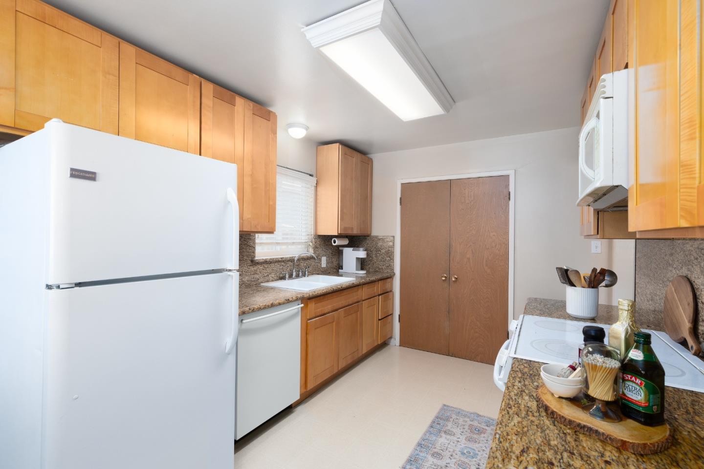 1226 Roxbury Court Santa Clara, CA 95050 - Photo 28 of 35 a white refrigerator freezer sitting inside of a kitchen