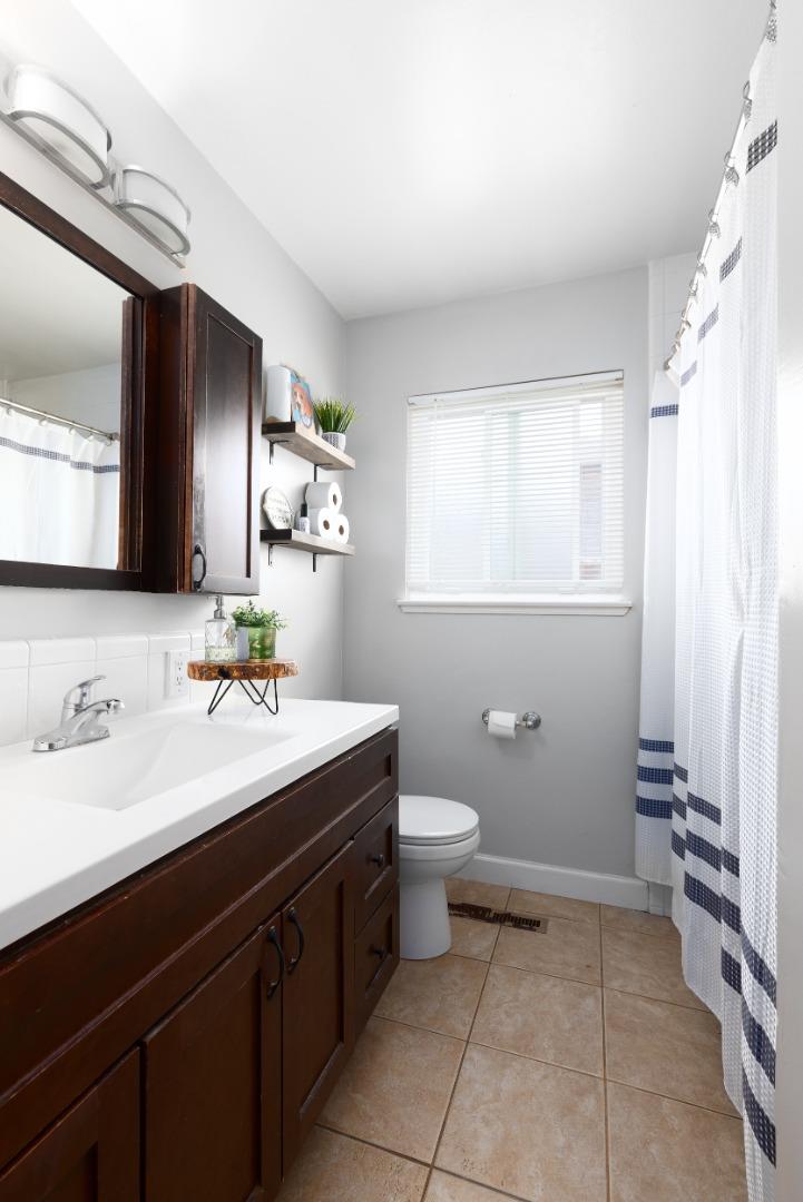 1226 Roxbury Court Santa Clara, CA 95050 - Photo 30 of 35 a bathroom with a sink toilet and mirror