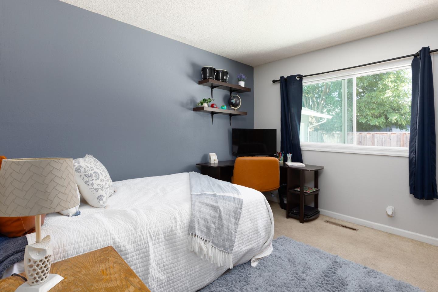 1226 Roxbury Court Santa Clara, CA 95050 - Photo 34 of 35 a bed sitting in a bedroom next to a window