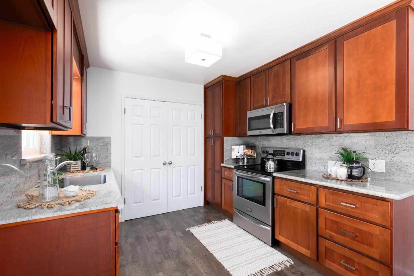 1226 Roxbury Court Santa Clara, CA 95050 - Photo 9 of 35 a kitchen with stainless steel appliances granite countertop wooden cabinets a stove top oven a sink and dishwasher