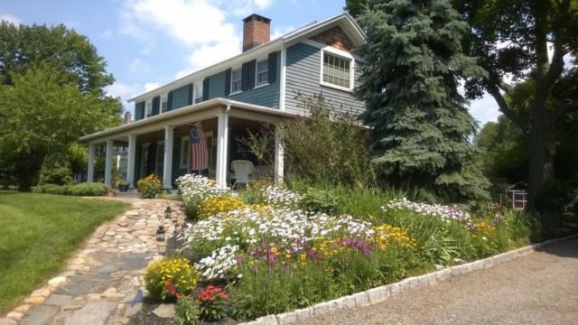 288 Stratfield Road Fairfield, CT 06825 - Photo 1 of 1 a front view of a house with a yard and fountain