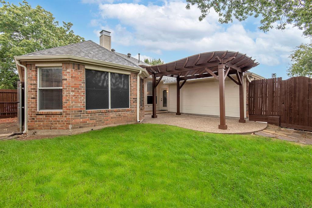 10217 Max Lane Frisco, TX 75035 - Photo 11 of 12 a view of a house with backyard and a garden