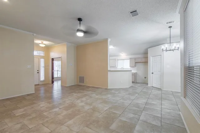 a view of a kitchen with a sink and a refrigerator