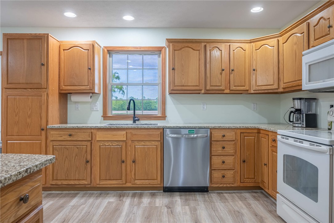 2645 Vance Road St. Paris, OH 43072 - Photo 13 of 35 This spacious kitchen offers ample wood cabinetry, granite counters, and a window above the sink.
