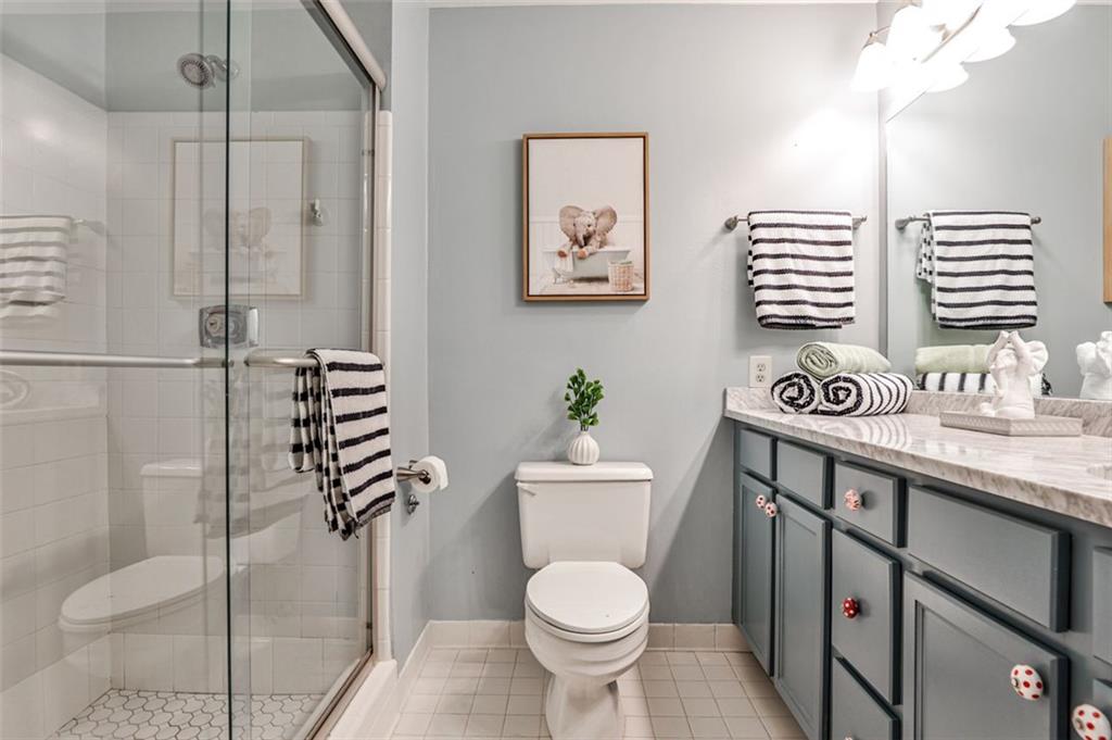 214 Ridley Howard Court Decatur, GA 30030 - Photo 17 of 28 a bathroom with a granite countertop sink toilet and a shower