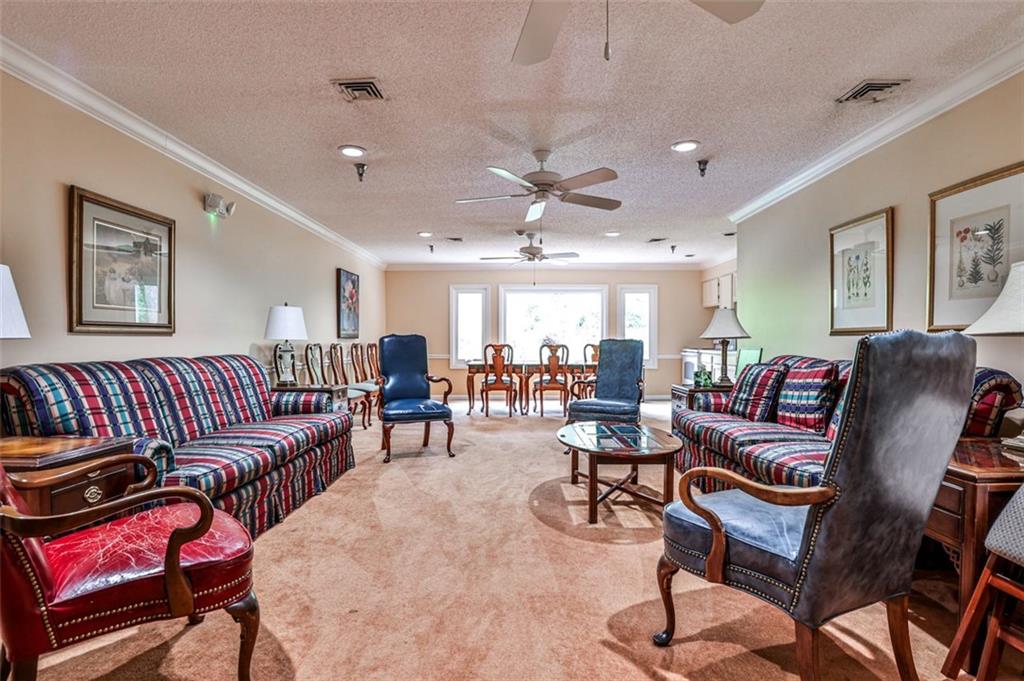 214 Ridley Howard Court Decatur, GA 30030 - Photo 26 of 28 a living room with furniture a wooden floor and a ceiling fan