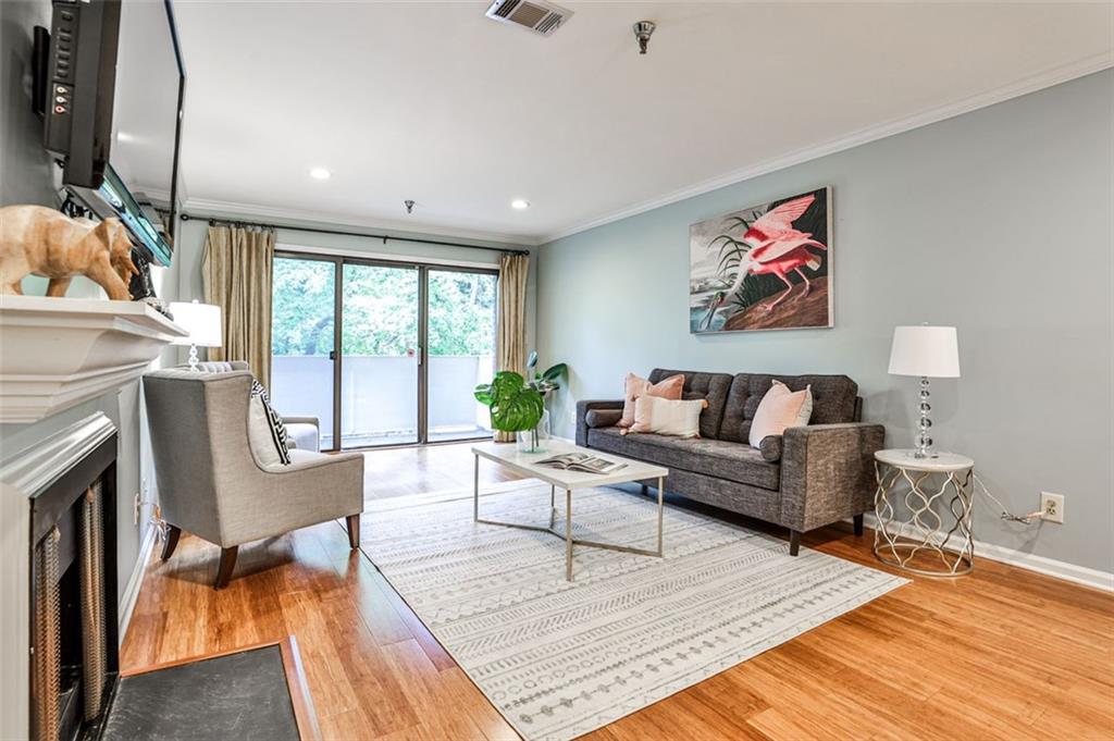 214 Ridley Howard Court Decatur, GA 30030 - Photo 4 of 28 a living room with furniture a fireplace and a floor to ceiling window