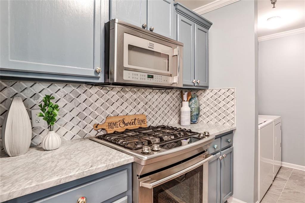 214 Ridley Howard Court Decatur, GA 30030 - Photo 7 of 28 a stove top oven sitting inside of a kitchen