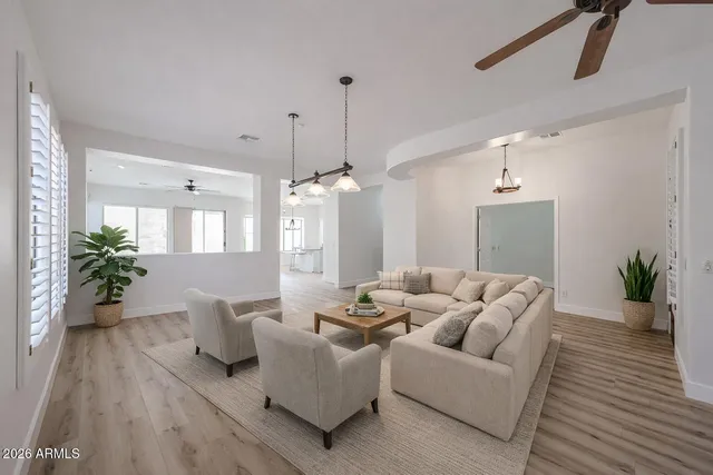 a view of an empty room with wooden floor and closet