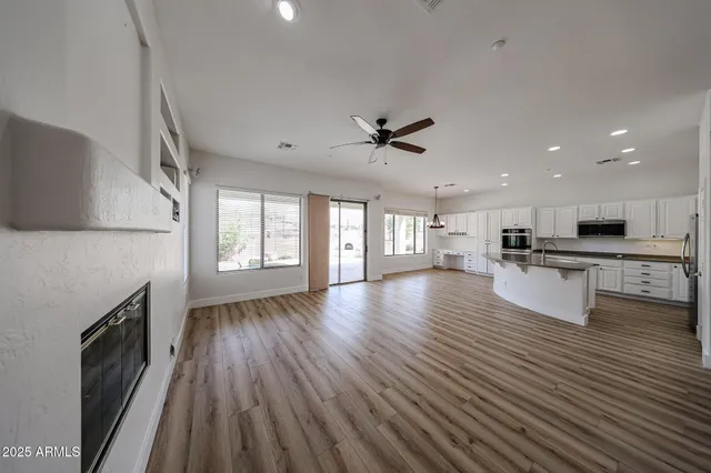 a view of kitchen with sink microwave and refrigerator
