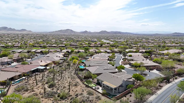 an aerial view of residential houses with outdoor space and trees