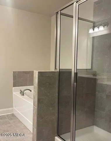 a bathroom with a bathtub and a shower