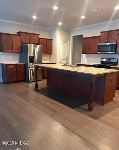 a large kitchen with stainless steel appliances and a sink