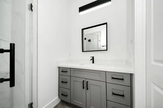 a bathroom with a sink and mirror