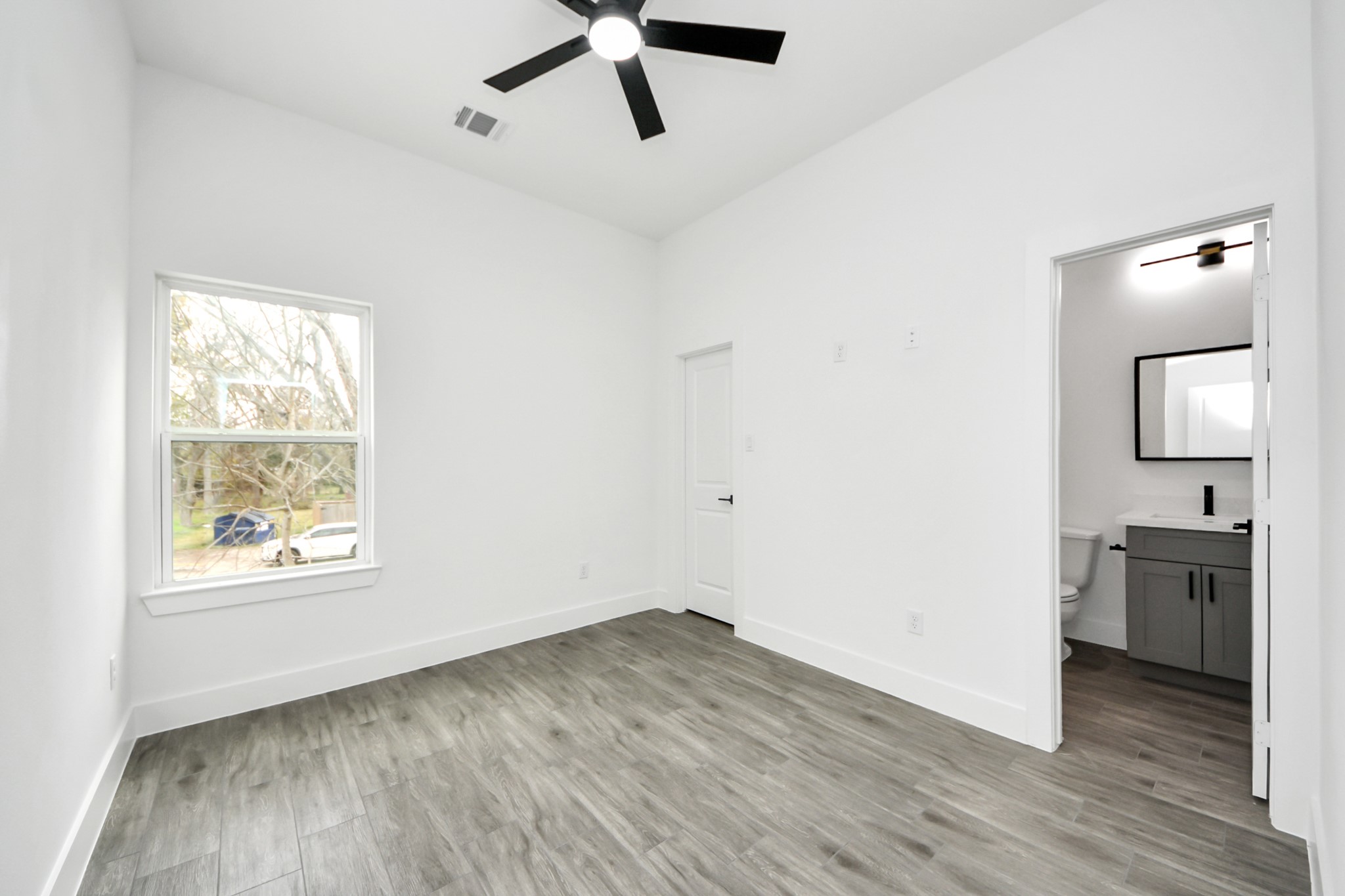 7412 Carver Road, Unit B Houston, TX 77088 - Photo 15 of 22 an empty room with wooden floor cabinet and windows