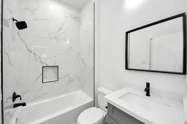 a bathroom with a sink toilet and shower