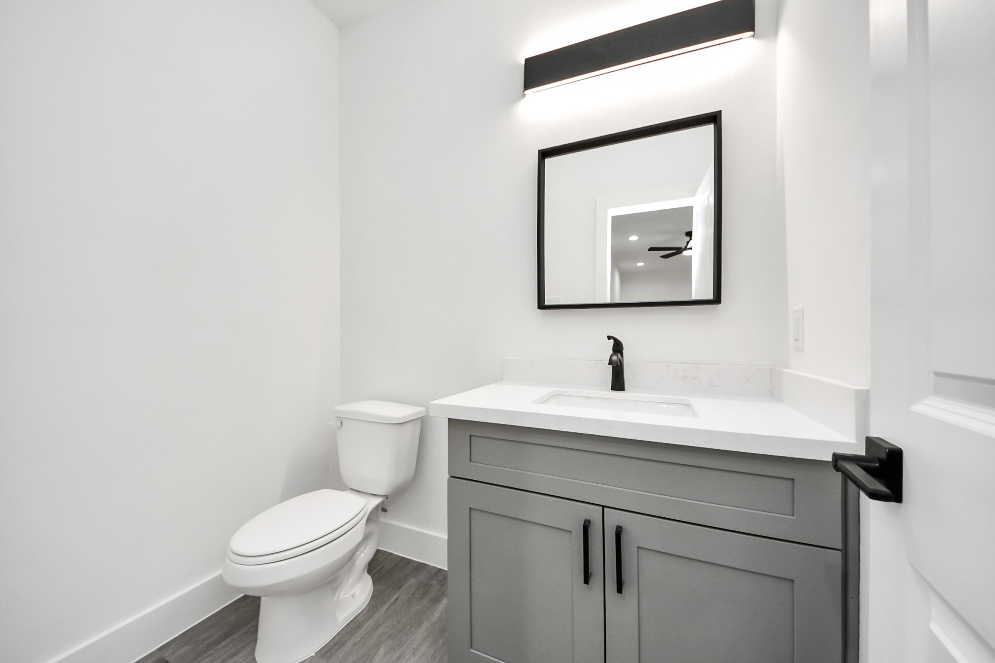 7412 Carver Road, Unit B Houston, TX 77088 - Photo 20 of 22 a bathroom with a toilet sink and mirror