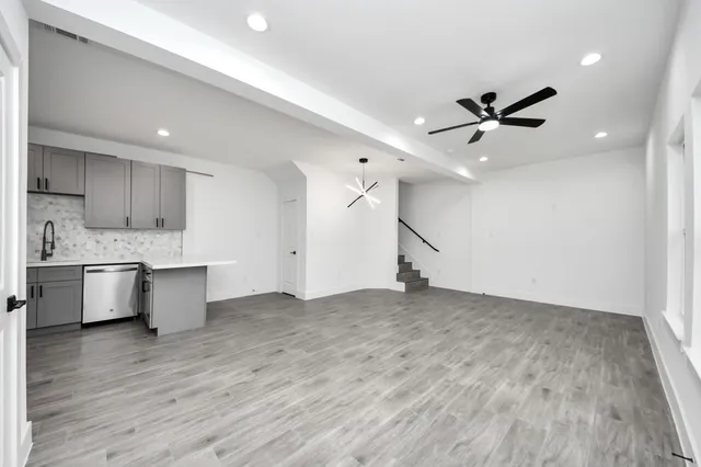 a view of a kitchen with a sink and a stove top oven