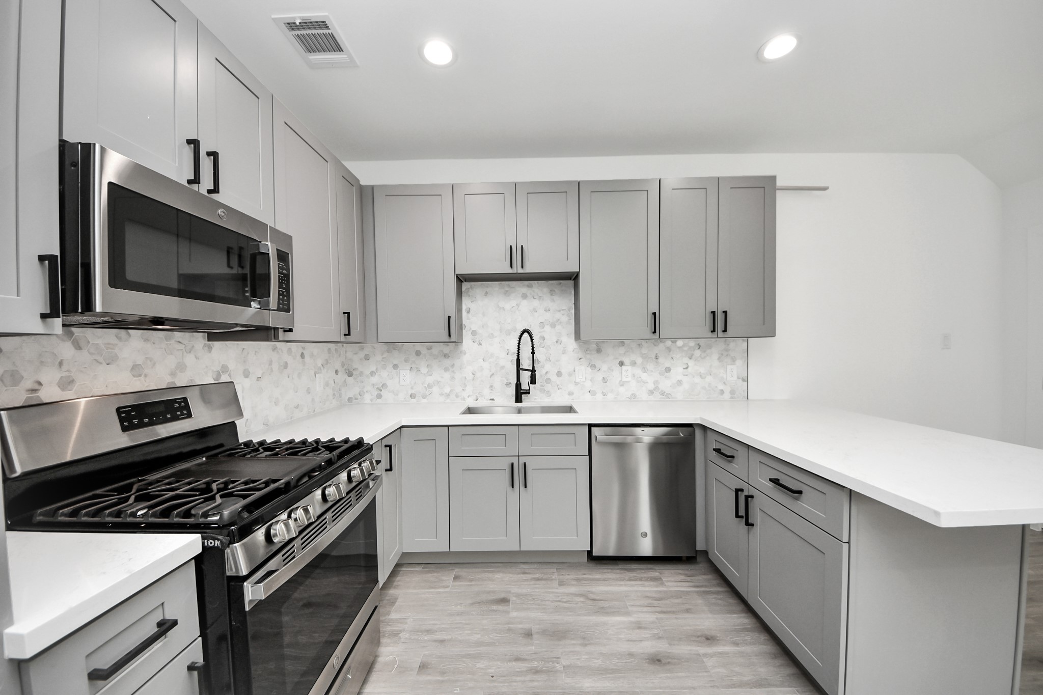 7412 Carver Road, Unit B Houston, TX 77088 - Photo 5 of 22 a kitchen with a sink stove and microwave