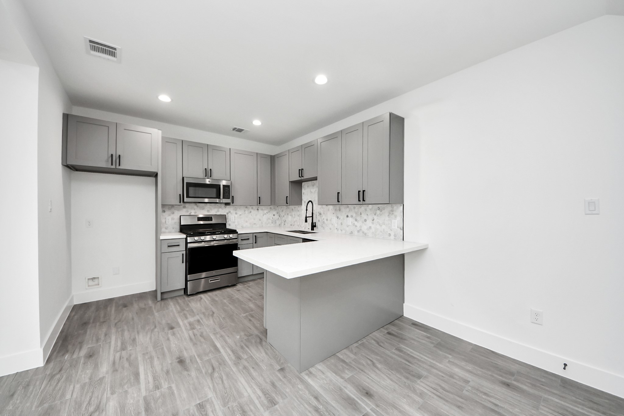 7412 Carver Road, Unit B Houston, TX 77088 - Photo 7 of 22 a kitchen with stainless steel appliances a sink stove and refrigerator