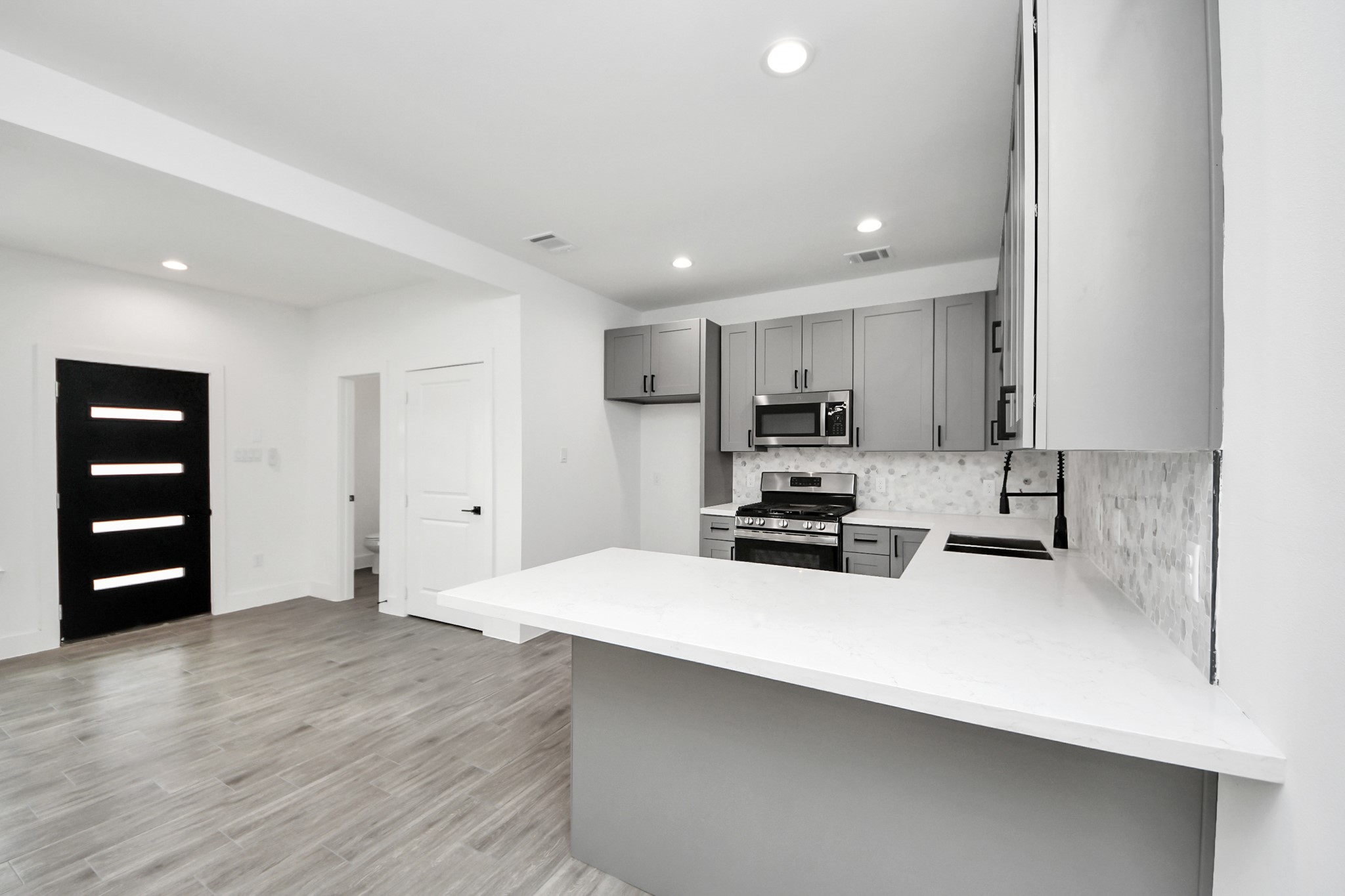 7412 Carver Road, Unit B Houston, TX 77088 - Photo 8 of 22 a kitchen with wooden cabinets and white appliances