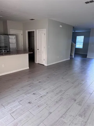 a view of a kitchen with a sink and a refrigerator