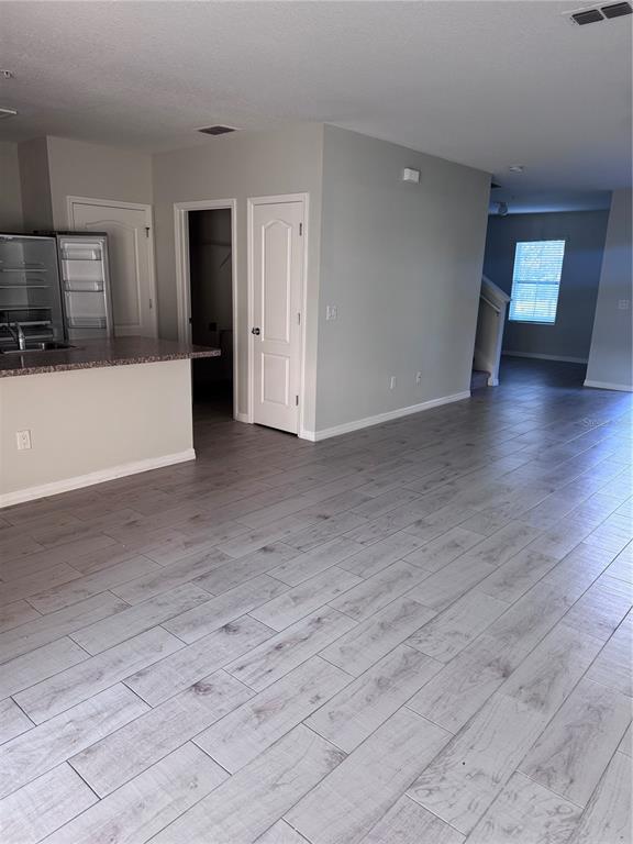 1613 Reflection Cove St. Cloud, FL 34771 - Photo 3 of 10 a view of a kitchen with a sink and a refrigerator