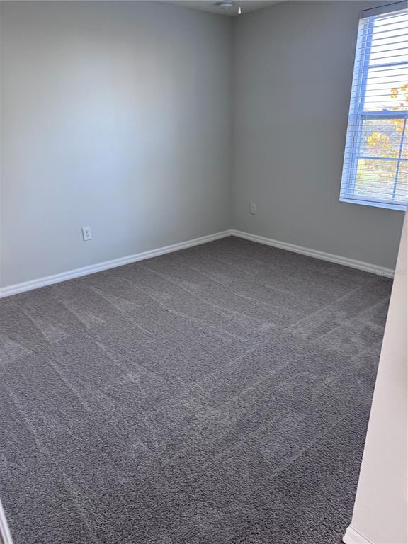 1613 Reflection Cove St. Cloud, FL 34771 - Photo 7 of 10 an empty room with a window