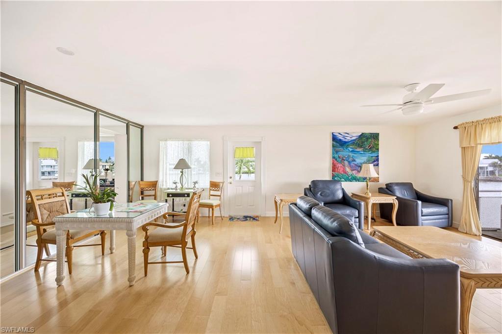 330 Kon Tiki Drive, Unit A2 Naples, FL 34113 - Photo 13 of 39 a living room with fireplace furniture and a large window