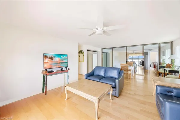 a living room with furniture and a wooden floor