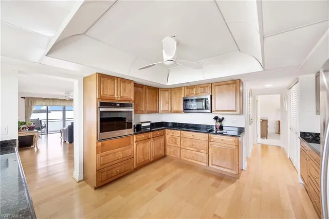 a large kitchen with cabinets and wooden floor